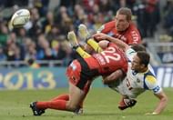 Clermont Auvergne's full back Lee Byrne (R) is tackled by Toulon's Frederic Michalak in Dublin on May 18, 2013